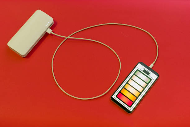 istock Smartphone is charging with power bank on red background 1206385088