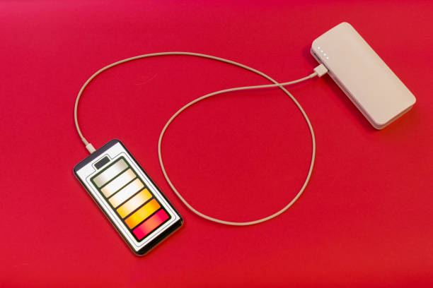 istock Smartphone is charging with power bank on red background 1206385104