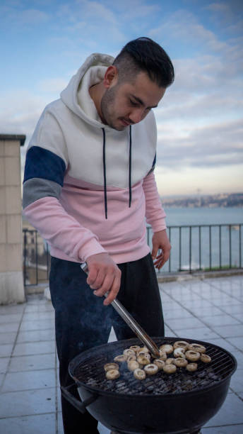 istock Man cooking  mushroom on bbq 1206385105