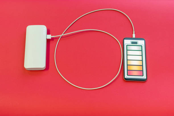 istock Smartphone is charging with power bank on red background 1206385122