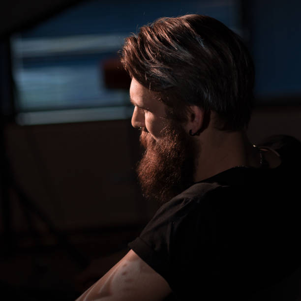 istock bearded serious man sitting in a chair 1206385879
