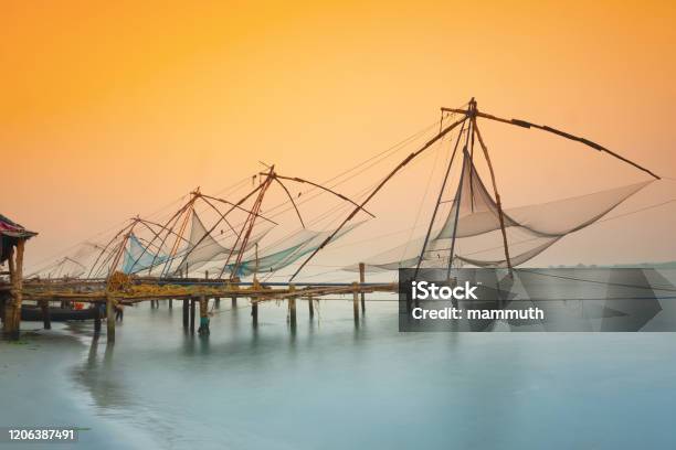 Traditional Chinese Fishing Nets In Kochi India At Sunrise Stock Photo - Download Image Now