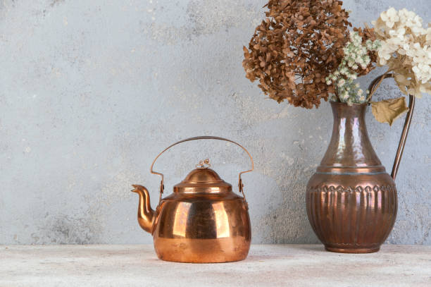 istock Vintage copper teapot on concrete background. 1206389251