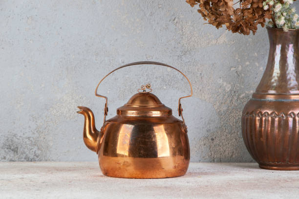 istock Vintage copper teapot on concrete background. 1206389286