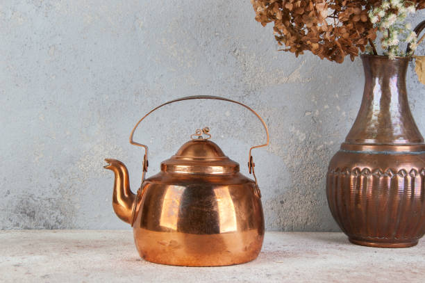 istock Vintage copper teapot on concrete background. 1206389316