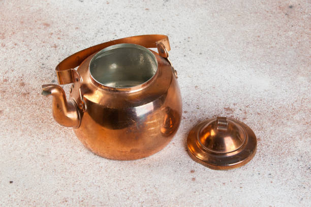 istock Vintage copper teapot on concrete background. 1206389348