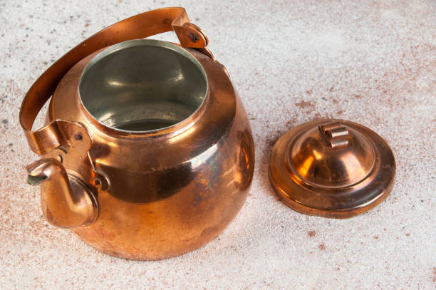 istock Vintage copper teapot on concrete background. 1206389389
