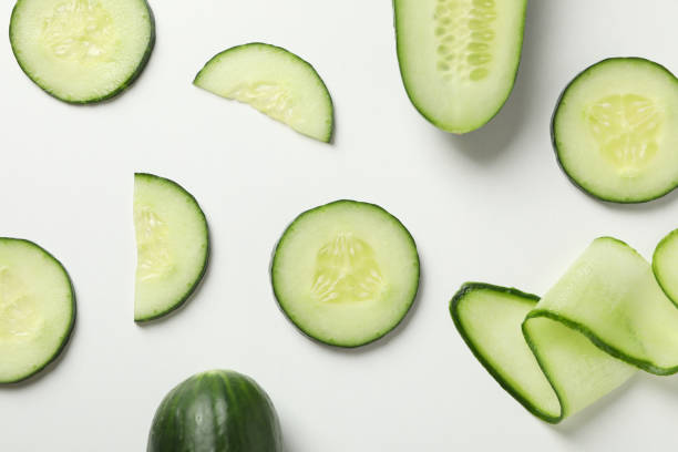 istock Fresh cucumber slices on white background, top view 1206392501