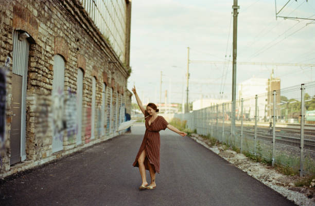 Young Caucasian woman dancing while walking  in Tallinn, Estonia