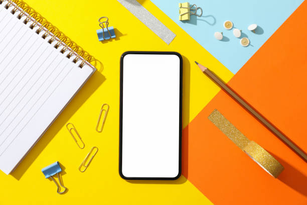 istock Phone with empty screen on color decorated background, top view 1206392950