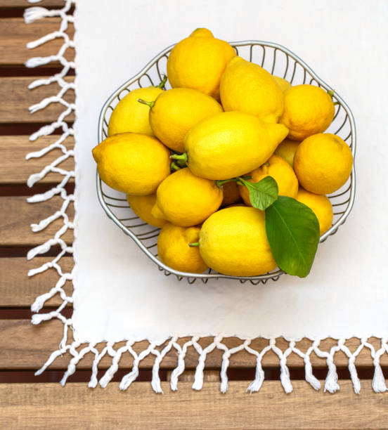 Yellow lemons in a vase