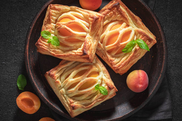 istock Yummy puff pastry stuffed with fresh peaches 1206393960