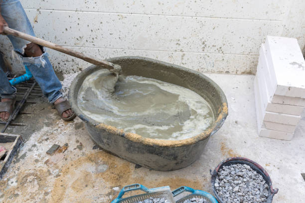 istock Concrete mixing step of sand cement and water by construction workers. 1206394158
