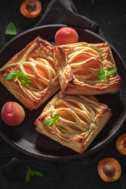 istock Tasty puff pastry with powdered sugar and fresh peaches 1206394991