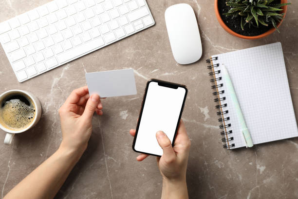 istock Female holding phone with empty screen. Workplace 1206395392