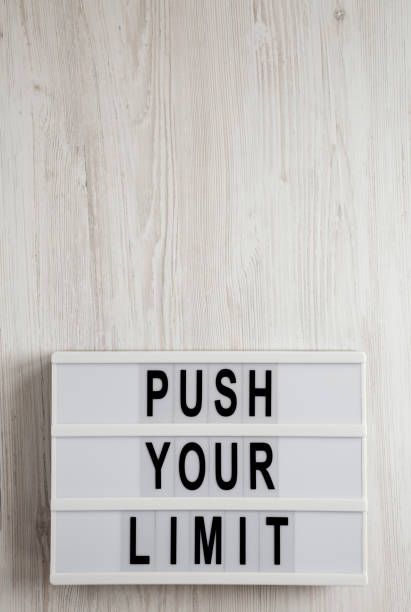istock 'Push your limit' words on a lightbox on a white wooden background, top view. Overhead, from above, flat lay. Copy space. 1206396220
