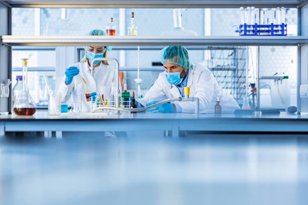 istock Two chemists working on poisonous liquid in a laboratory. 1206396360