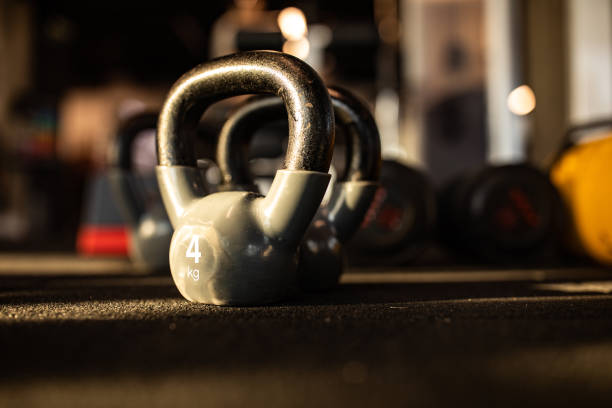 Close up of kettle bells on the floor in a gym. Copy space.