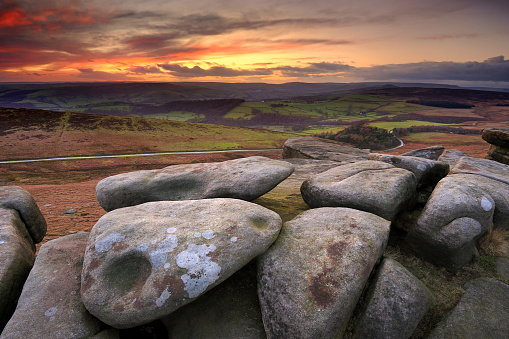 Wide angle view of large boulders on Stanage Edge at sunset in the Peak District National Park, Derbyshire, England, UK