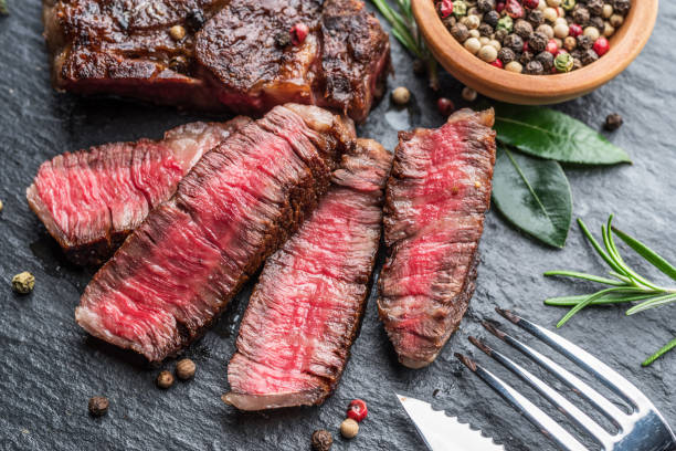 istock Medium rare Ribeye steak with herbs on graphite board. 1206400141