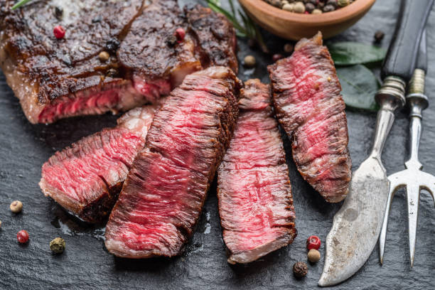 istock Medium rare Ribeye steak with herbs on graphite board. 1206401128