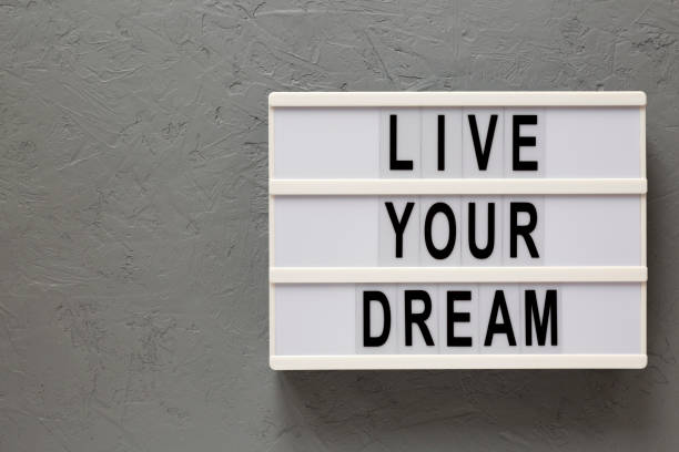 istock 'Live your dream' words on a modern board on a gray background, top view. Overhead, from above, flat lay. Copy space. 1206402521