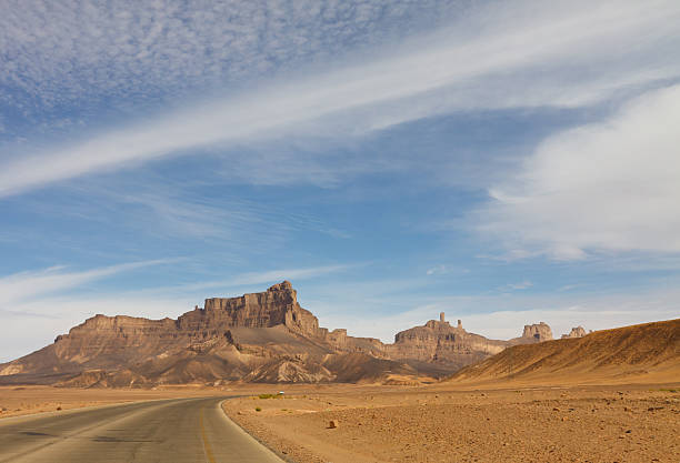 autostrada nel deserto, akakus (acacus) montagne, sahara libya - arid climate asphalt barren blue foto e immagini stock