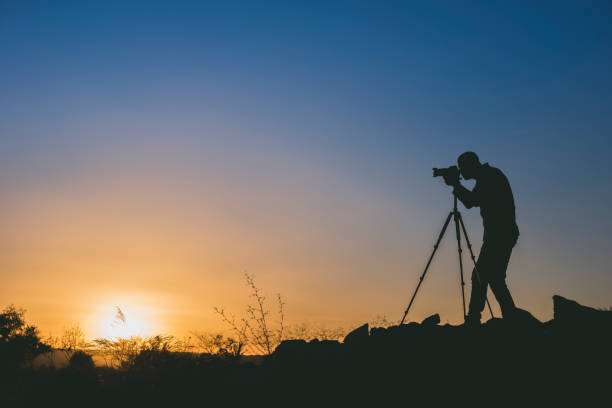istock Silhouette of a photographer at sunset with copy space 1206403648