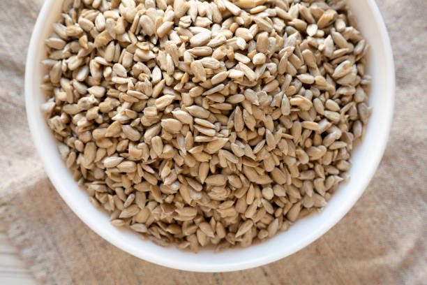 istock Raw Sunflower Seed Kernels in a white bowl, view from above. Flat lay, top view, overhead. 1206405494