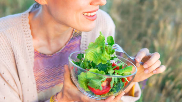 istock Beautiful caucasian woman eating salad 1206407049