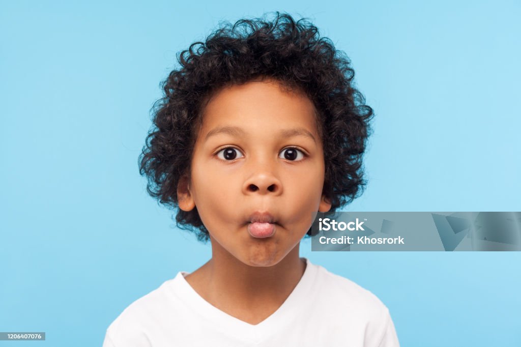 Closeup Portrait Of Funny Goofy Little Boy With Curly Hair Making Fish Face  With Pout Lips And Big Eyes Stock Photo - Download Image Now - iStock