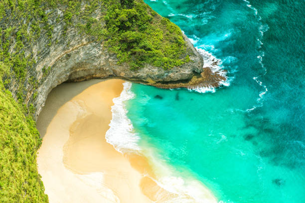 istock Sea rocks sand beach turquoise ocean water 1206408884