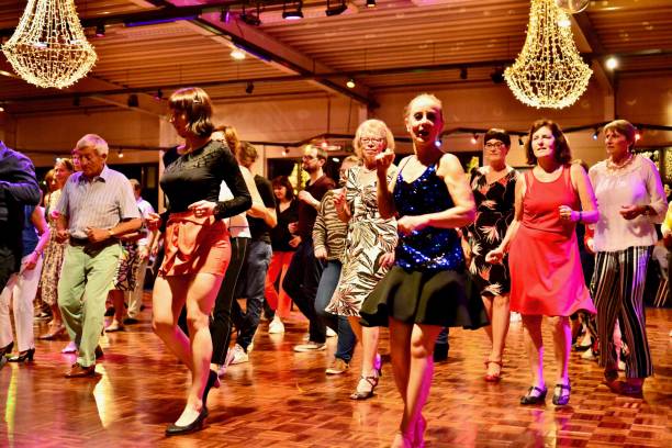 Workshop classes. Indoor line dancing by a professional instructor. Herent, Belgium - September 14, 2019: Open House indoor dancing classes evening show. Photo reportage open door promotion dance classes. Courses starting half September. Teacher in front of group demonstrates solo dance. teacher retirement party stock pictures, royalty-free photos & images