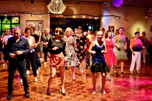 Workshop classes. Indoor line dancing by a professional instructor. Herent, Belgium - September 14, 2019: Open House indoor dancing classes evening show. Photo reportage open door promotion indoor dance classes. Courses starting half September. Teacher in front of group demonstrates solo dance. teacher retirement party stock pictures, royalty-free photos & images