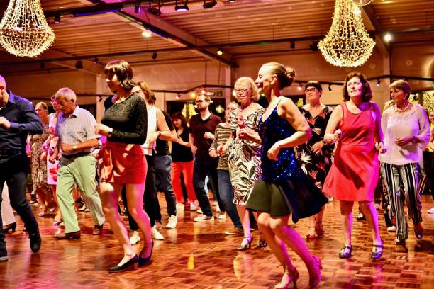 Workshop classes. Indoor line dancing by a professional instructor. Herent, Belgium - September 14, 2019: Open House indoor dancing classes evening show. Photo reportage open door promotion indoor dance classes. Courses starting half September. Teacher in front of group demonstrates solo dance. teacher retirement party stock pictures, royalty-free photos & images