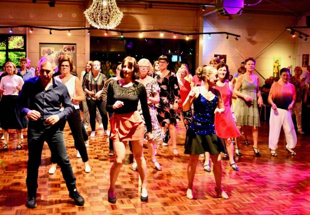 Workshop classes. Indoor line dancing by a professional instructor. Herent, Belgium - September 14, 2019: Open House indoor dancing classes evening show. Photo reportage open door promotion indoor dance classes. Courses starting half September. Teacher in front of group demonstrates solo dance. teacher retirement party stock pictures, royalty-free photos & images