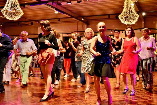 Workshop classes. Indoor line dancing by a professional instructor. Herent, Belgium - September 14, 2019: Open House indoor dancing classes evening show. Photo reportage open door promotion indoor dance classes. Courses starting half September. Teacher in front of group demonstrates solo dance. teacher retirement party stock pictures, royalty-free photos & images