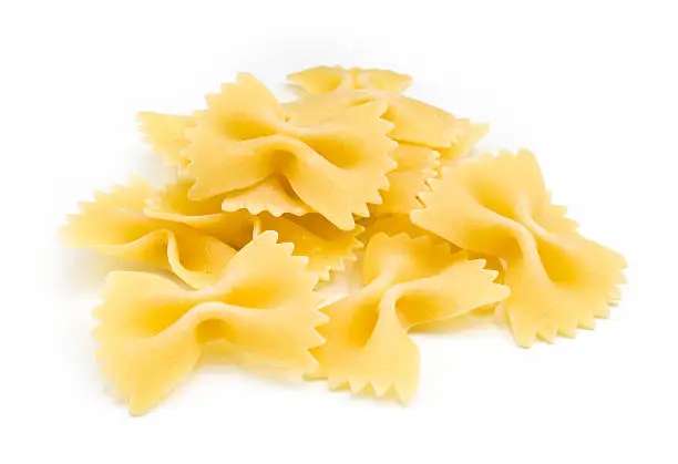 A portion of Farfalle bows pasta isolated on white
