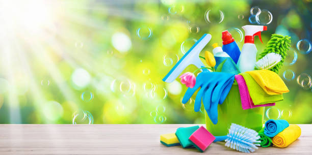 istock Bucket with cleaning items with sun beams and soapbubbles 1206411346
