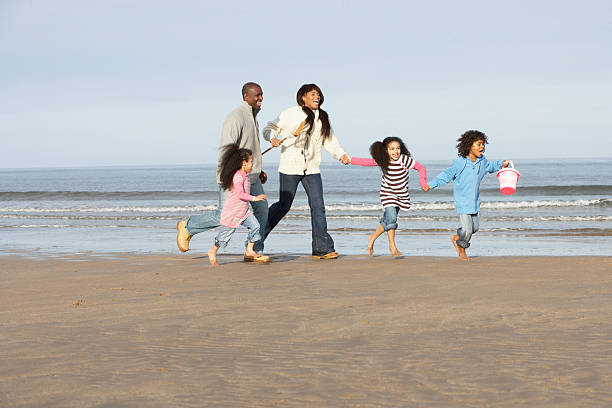 istock Family Running On Beach 120641153