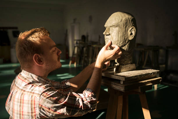 istock Sculptor working with clay sculpture of a human head 1206411687