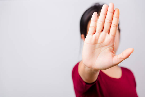 istock Asian beautiful woman itching her outstretched hand showing stop gesture front face, focus on hand 1206411762