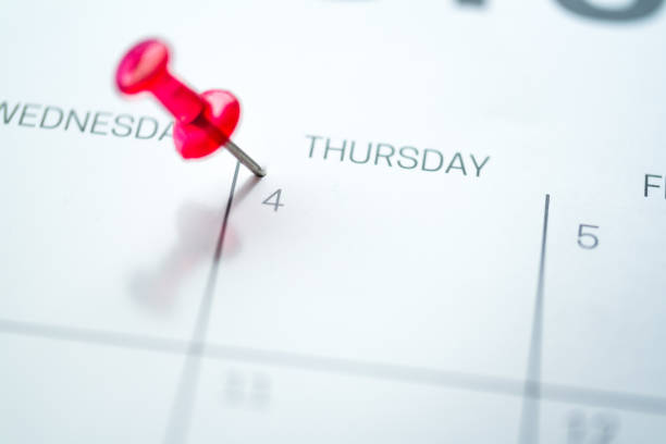 istock Red push pin on calendar 1206411790