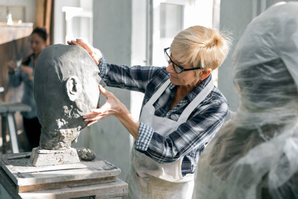 istock Senior woman making statue of clay in studio workshop 1206411815