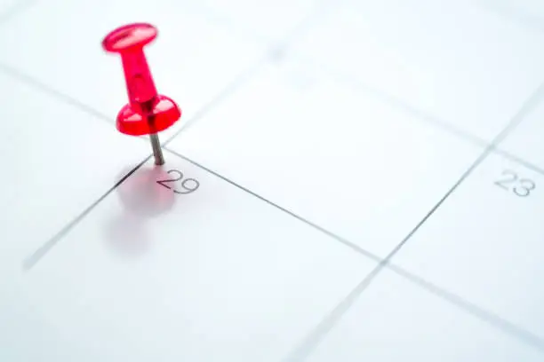 Red push pin on calendar 29th leap year day of the month