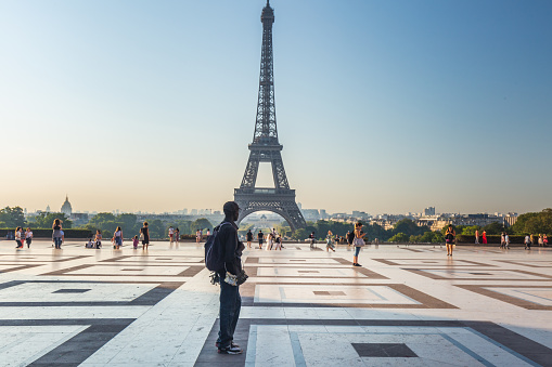 African immigrant sell souvenirs of small Eiffel Tower . Paris, France - July 27 2018.