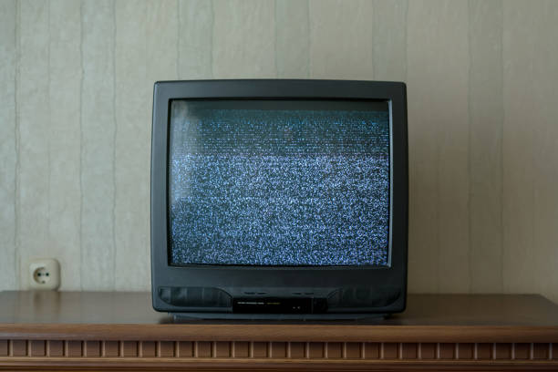 black old TV with static on screen black old TV with static on screen standing on wooden table in room of home old television stock pictures, royalty-free photos & images
