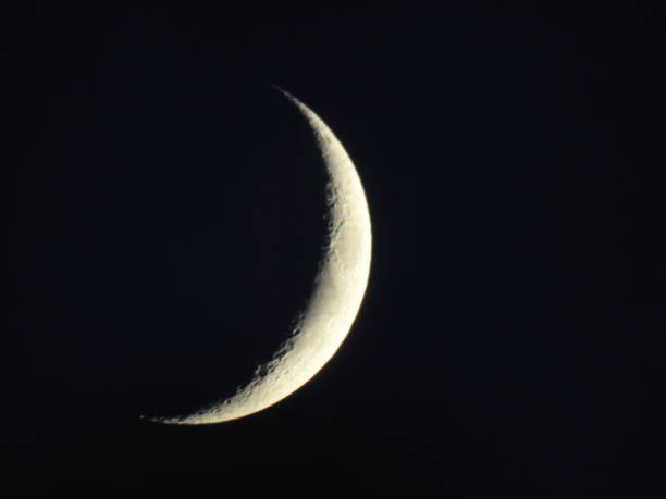 istock Narrow crescent moon on black sky at night 1206418975