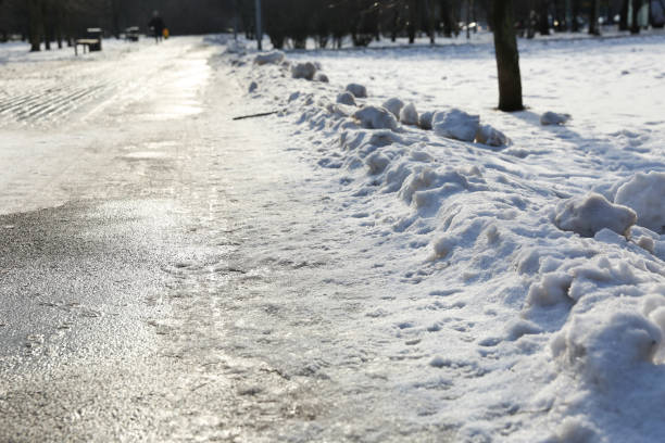 istock sidewalk with snow in winter 1206421613