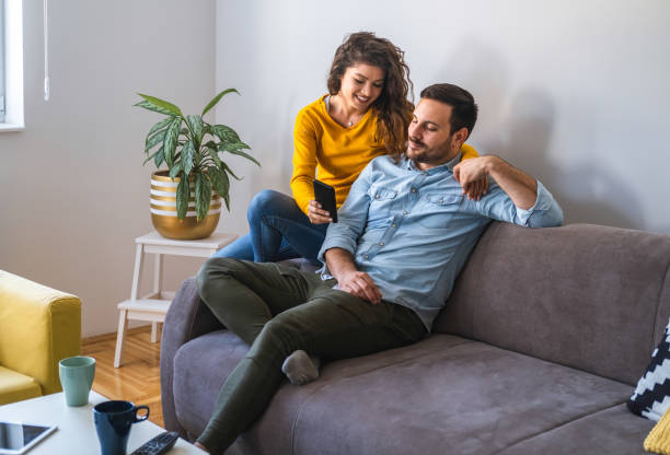 istock Happy couple using mobile phone stock photo 1206421634